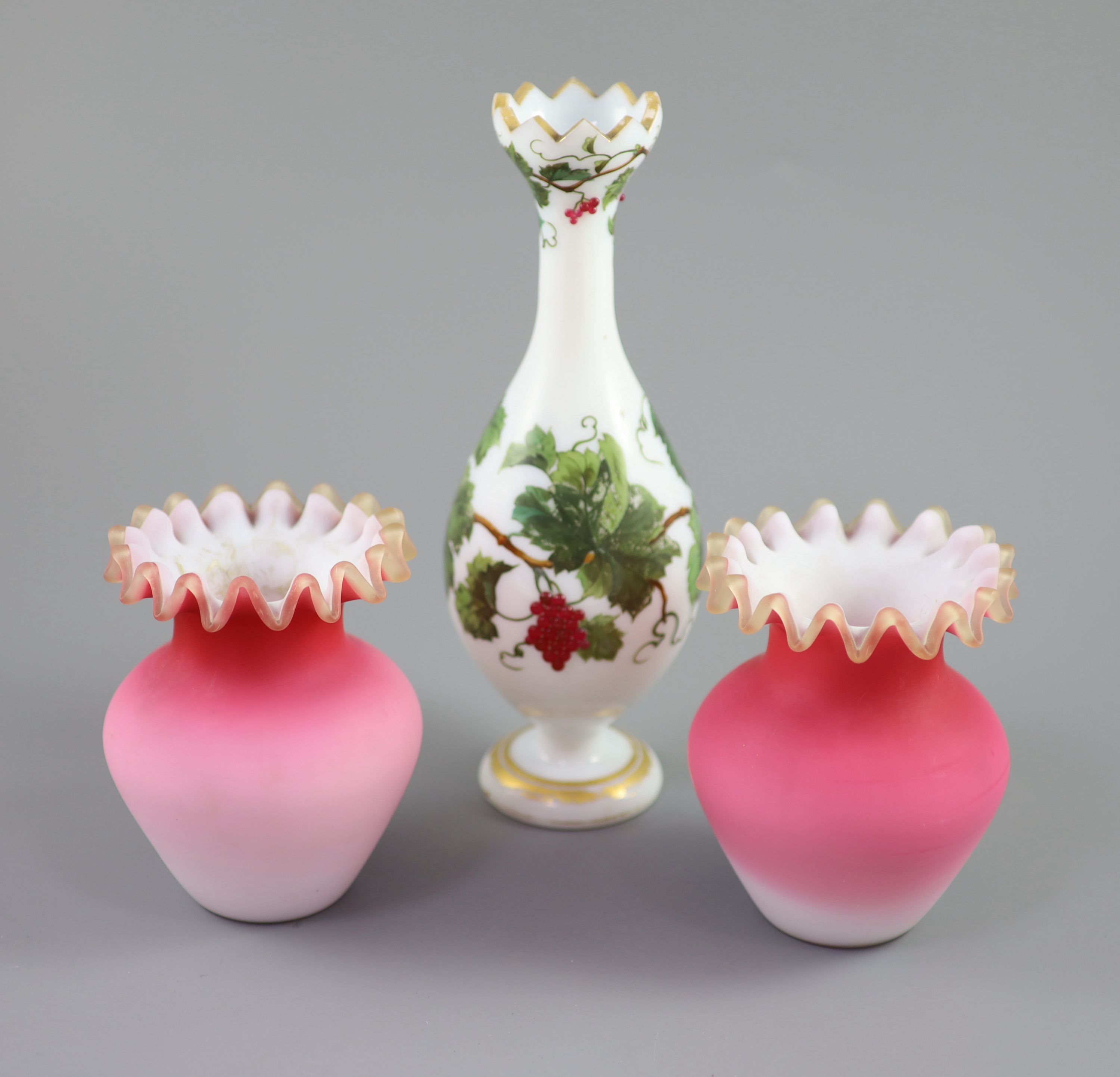 A French opaline glass vase with applied grapes and a pair of Webb style ruby and white glass vases, tallest 26cm